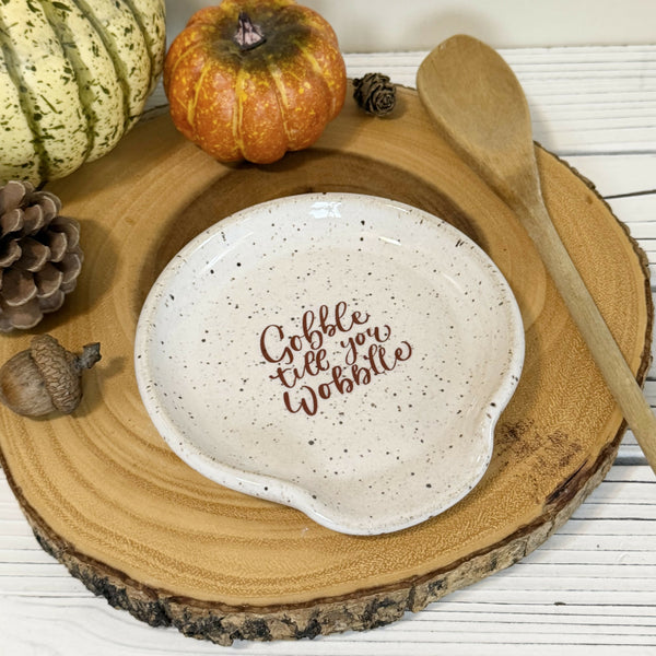 “Gobble till you wobble” on white speckled Spoon rest