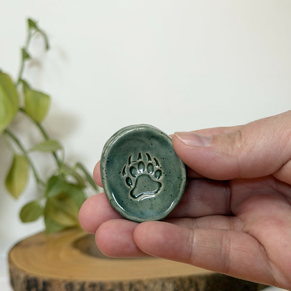 Green paw patterned calming stone