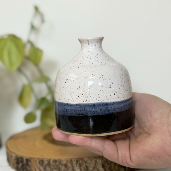 White and black speckled pottery bud vase