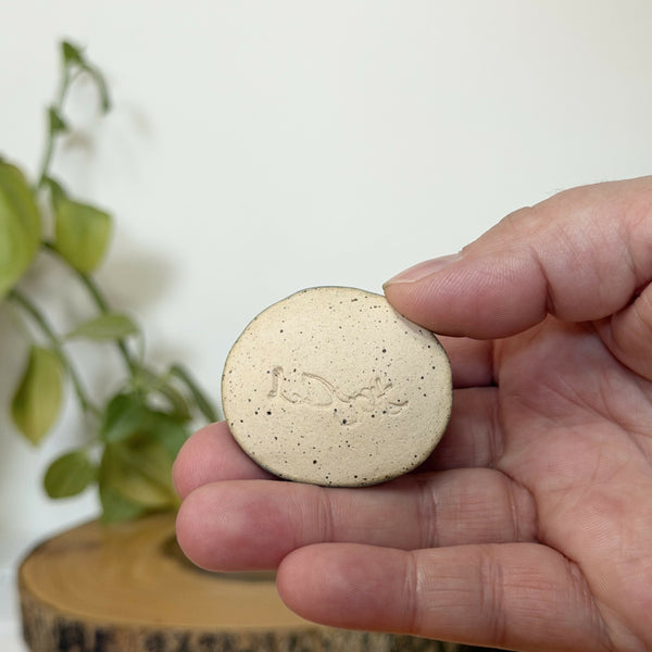 Green paw patterned calming stone
