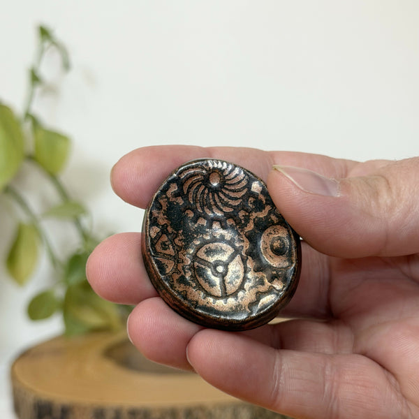 Brass gear pattern calming stone