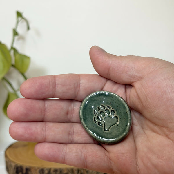 Green paw patterned calming stone