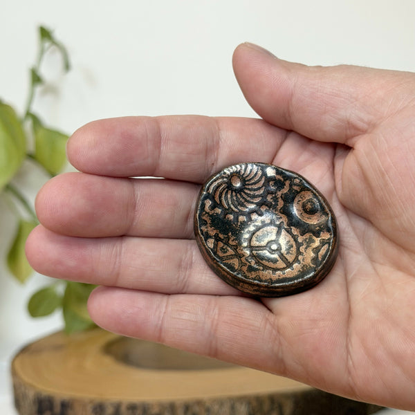 Brass gear pattern calming stone