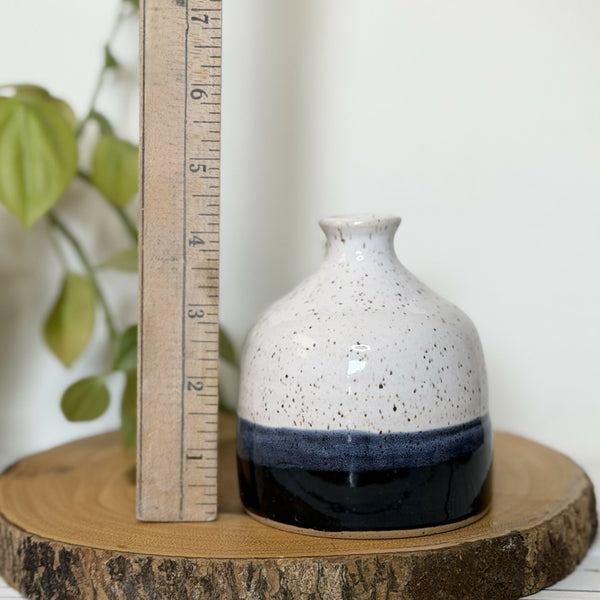 White and black speckled pottery bud vase