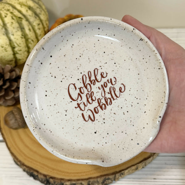 “Gobble till you wobble” on white speckled Spoon rest