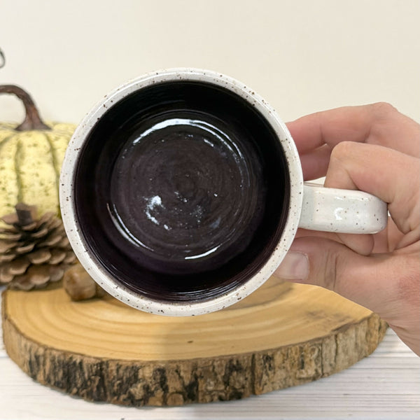 14 oz. Skeleton patterned white speckled mug with dark purple inside