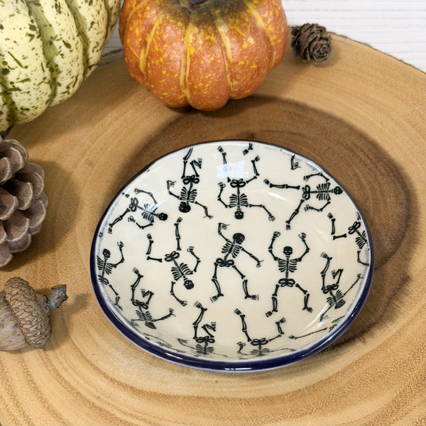Skeleton patterned ring dish with purple rim
