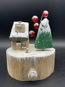 Little house on a slice with green tree